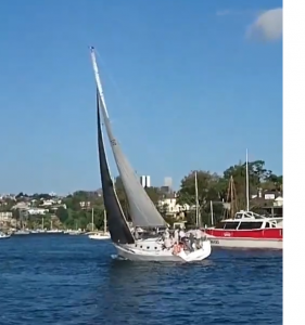 A screenshot from the Video on the Greenwich Flying Squadron Facebook page showing the appropriate twist in the leech of the mainsail